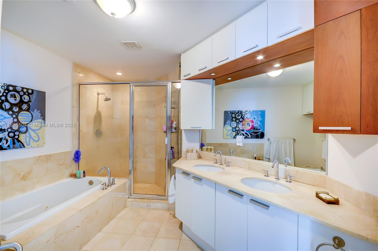 3131 Northeast 188th Street, Unit 1808 Aventura, FL 33180 - Photo 39 of 72 a bathroom with a tub a sink and a large mirror