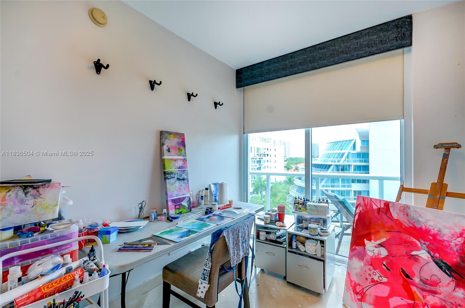 3131 Northeast 188th Street, Unit 1808 Aventura, FL 33180 - Photo 45 of 72 a living room with furniture and a floor to ceiling window