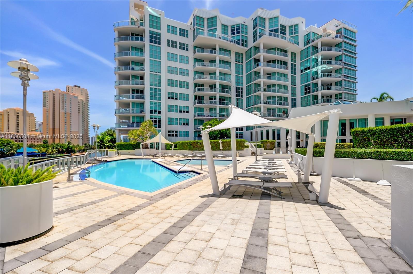 3131 Northeast 188th Street, Unit 1808 Aventura, FL 33180 - Photo 59 of 72 a view of a swimming pool and a patio