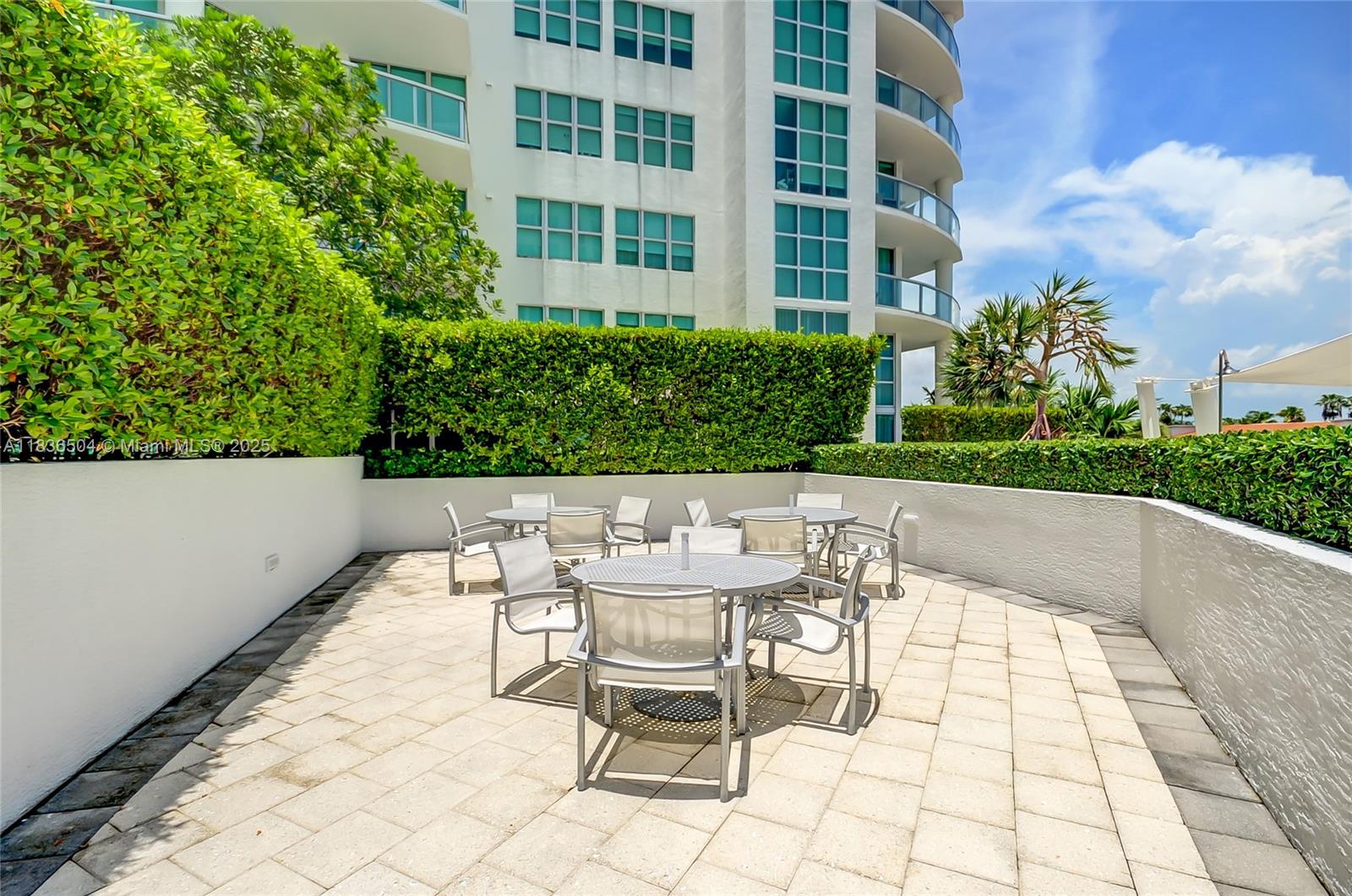 3131 Northeast 188th Street, Unit 1808 Aventura, FL 33180 - Photo 64 of 72 a view of a patio with a table and chairs in patio