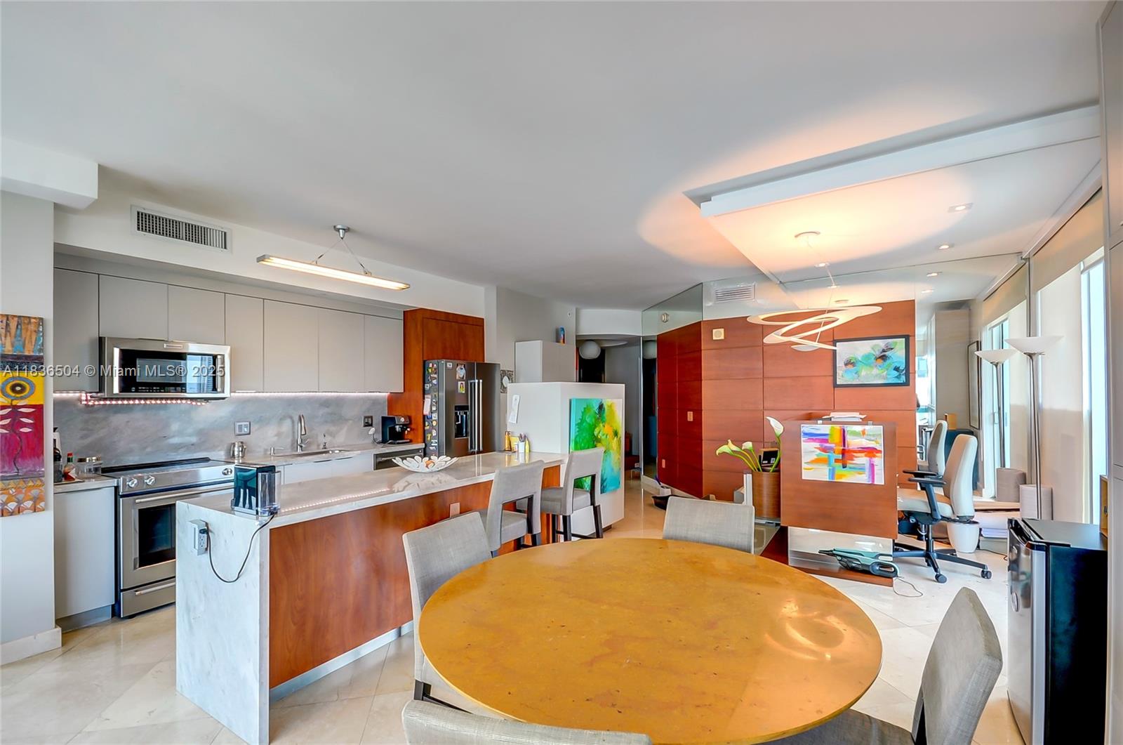 3131 Northeast 188th Street, Unit 1808 Aventura, FL 33180 - Photo 7 of 72 a room with stainless steel appliances kitchen island granite countertop a sink and cabinets
