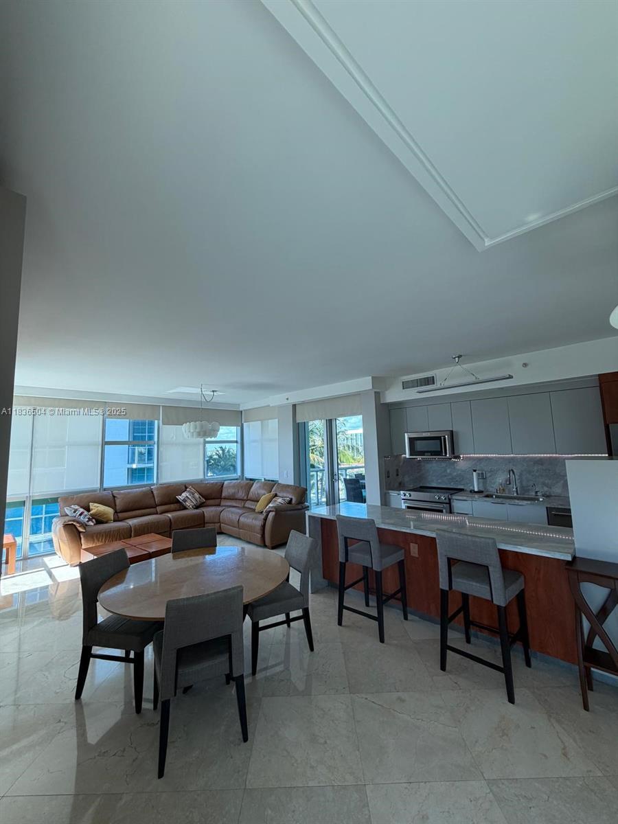 3131 Northeast 188th Street, Unit 1808 Aventura, FL 33180 - Photo 8 of 72 a view of a dining room with furniture and a window