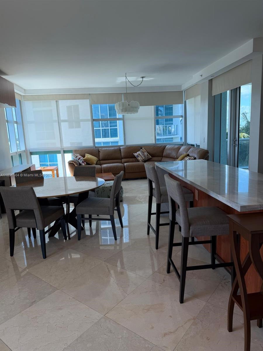 3131 Northeast 188th Street, Unit 1808 Aventura, FL 33180 - Photo 9 of 72 a view of a a dining room with furniture window and wooden floor