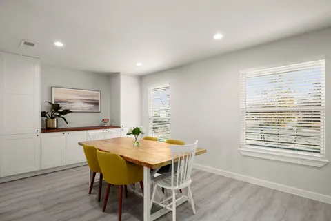 a view of a dining room with furniture window and wooden floor