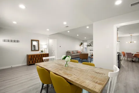 a dining room with furniture and wooden floor