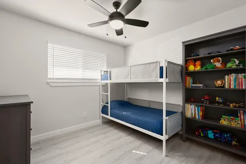 a bedroom with bed and a bookshelf