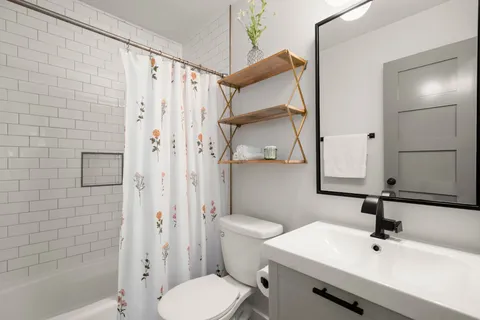 a bathroom with a sink toilet and shower