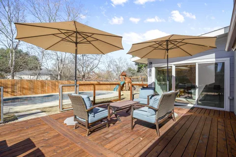 a view of a patio with a table and chairs under an umbrella
