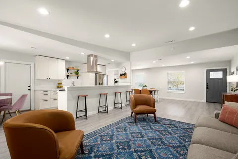 a living room with furniture and kitchen view