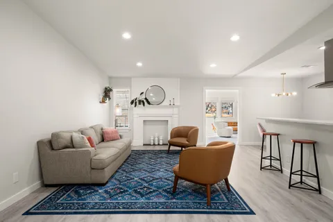 a living room with furniture rug and window