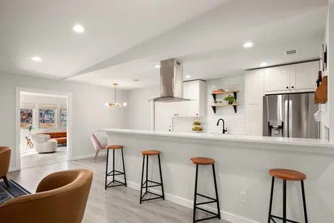 a kitchen with stainless steel appliances granite countertop sink microwave and wooden floor