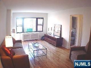 2175 North Central Road, Unit A Fort Lee, NJ 07024 - Photo 8 of 8 a living room with furniture and a large window