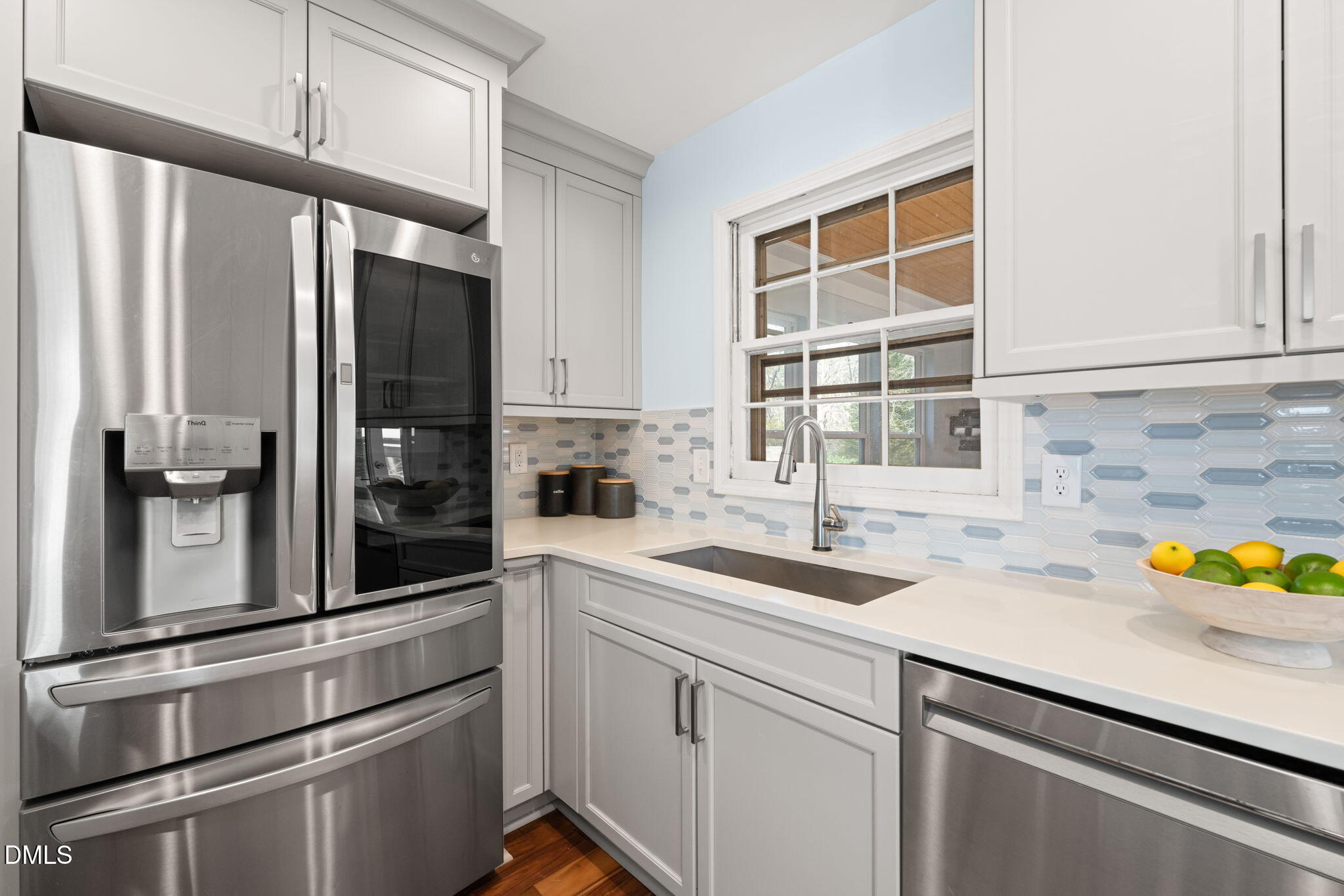 1004 Woodhill Court Raleigh, NC 27615 - Photo 11 of 43 a kitchen with a sink and refrigerator
