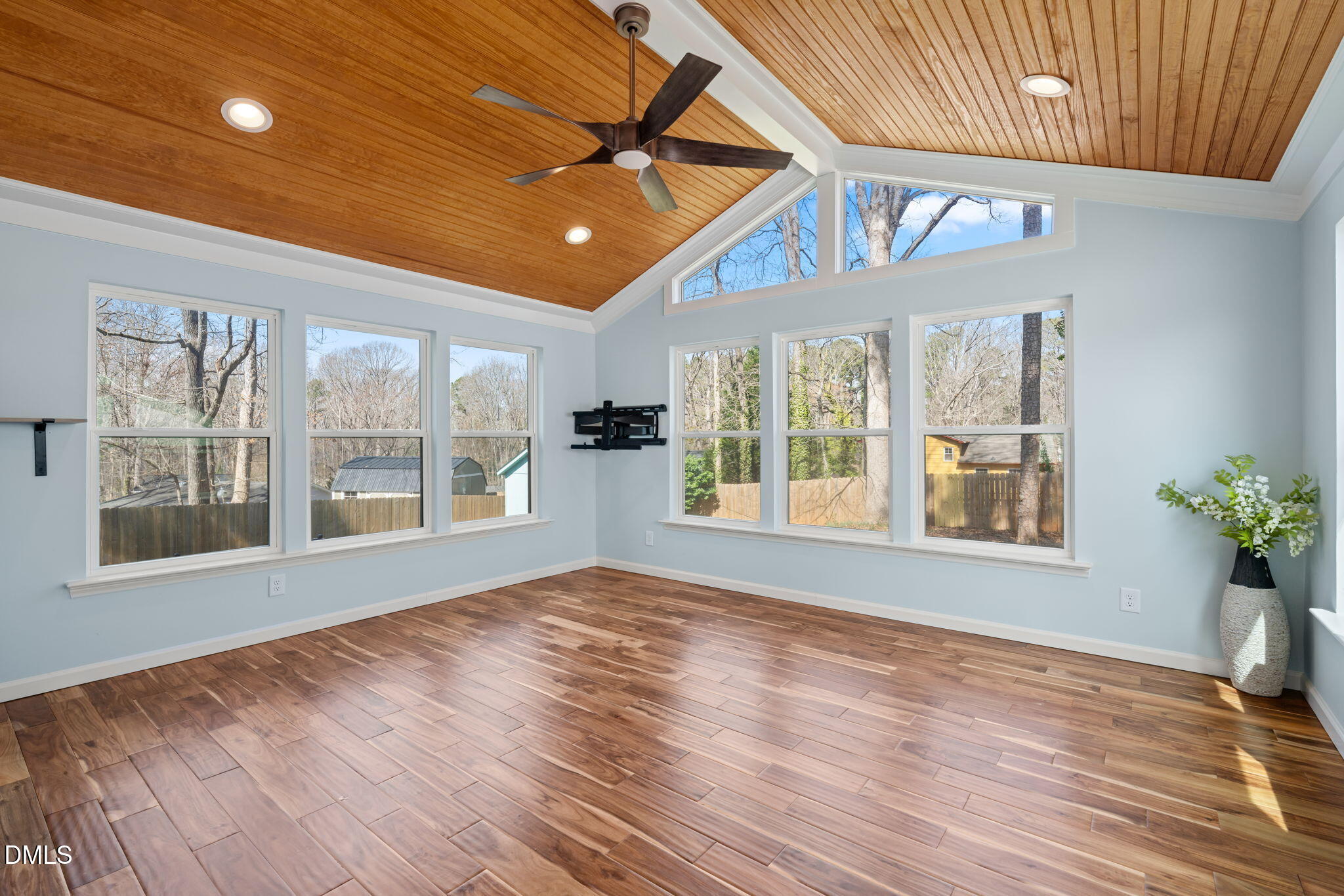 1004 Woodhill Court Raleigh, NC 27615 - Photo 13 of 43 a view of an empty room with a window and wooden floor
