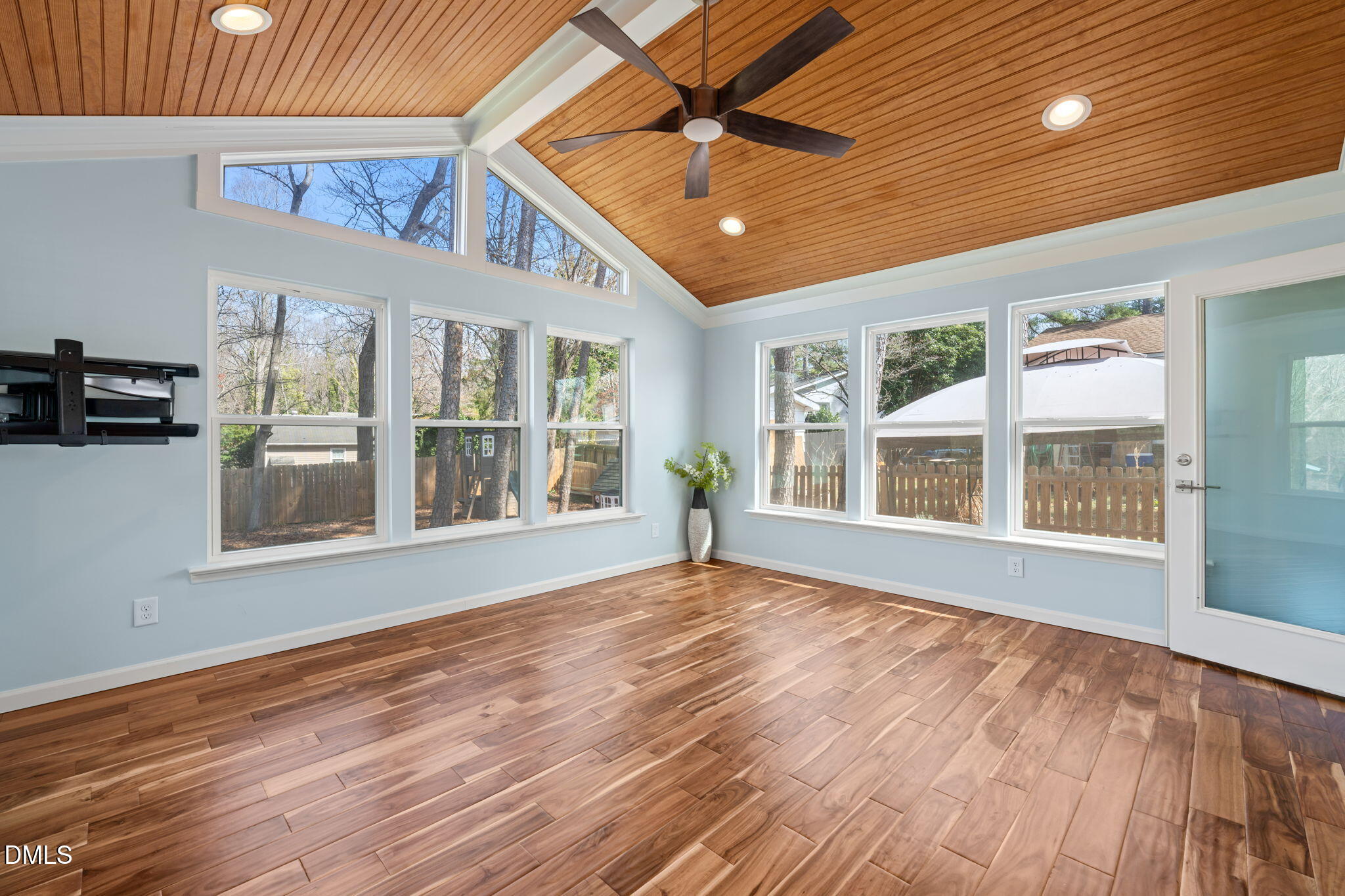 1004 Woodhill Court Raleigh, NC 27615 - Photo 14 of 43 a view of an empty room with a window and wooden floor