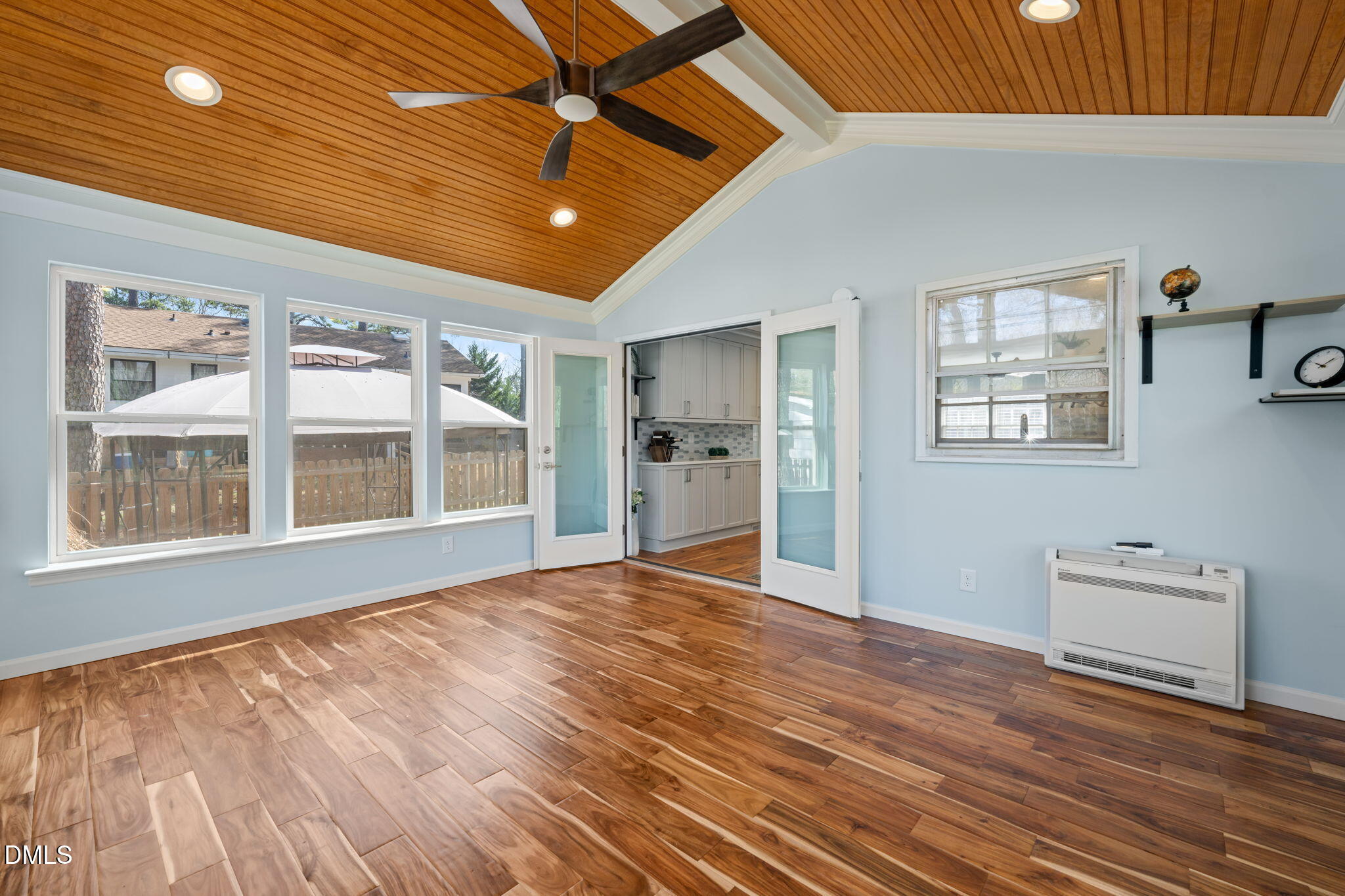 1004 Woodhill Court Raleigh, NC 27615 - Photo 15 of 43 a view of an empty room with a window and wooden floor