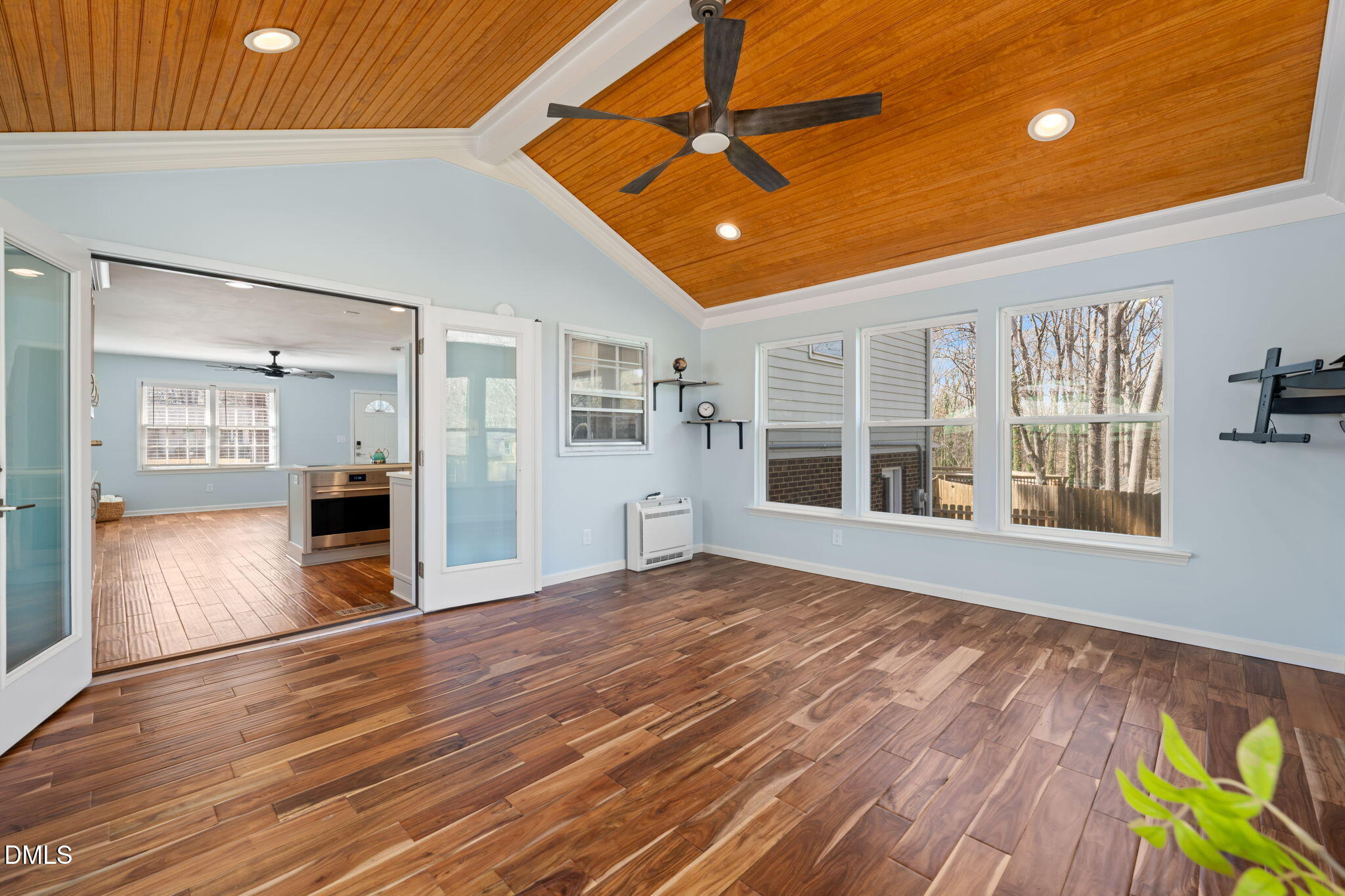 1004 Woodhill Court Raleigh, NC 27615 - Photo 16 of 43 a view of an empty room with wooden floor and a window