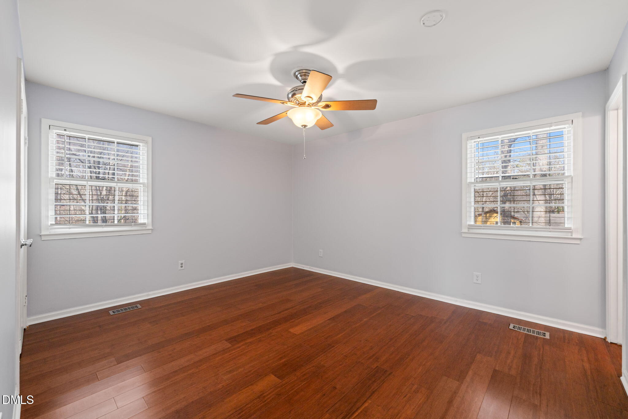 1004 Woodhill Court Raleigh, NC 27615 - Photo 17 of 43 a view of empty room with wooden floor and fan