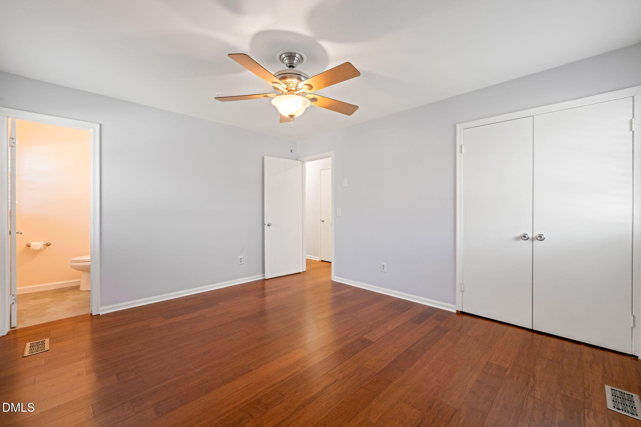 1004 Woodhill Court Raleigh, NC 27615 - Photo 18 of 43 an empty room with wooden floor closet and fan