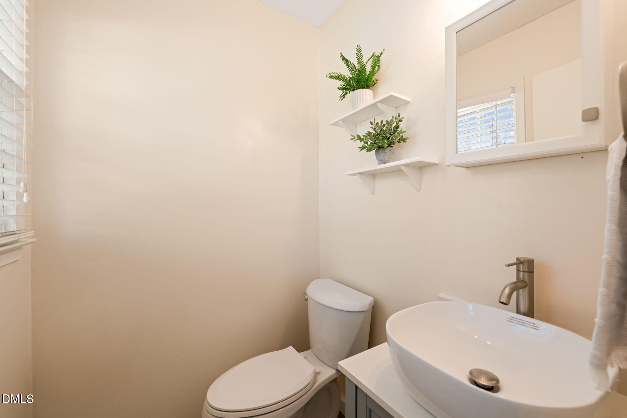 1004 Woodhill Court Raleigh, NC 27615 - Photo 19 of 43 a bathroom with a sink and a toilet