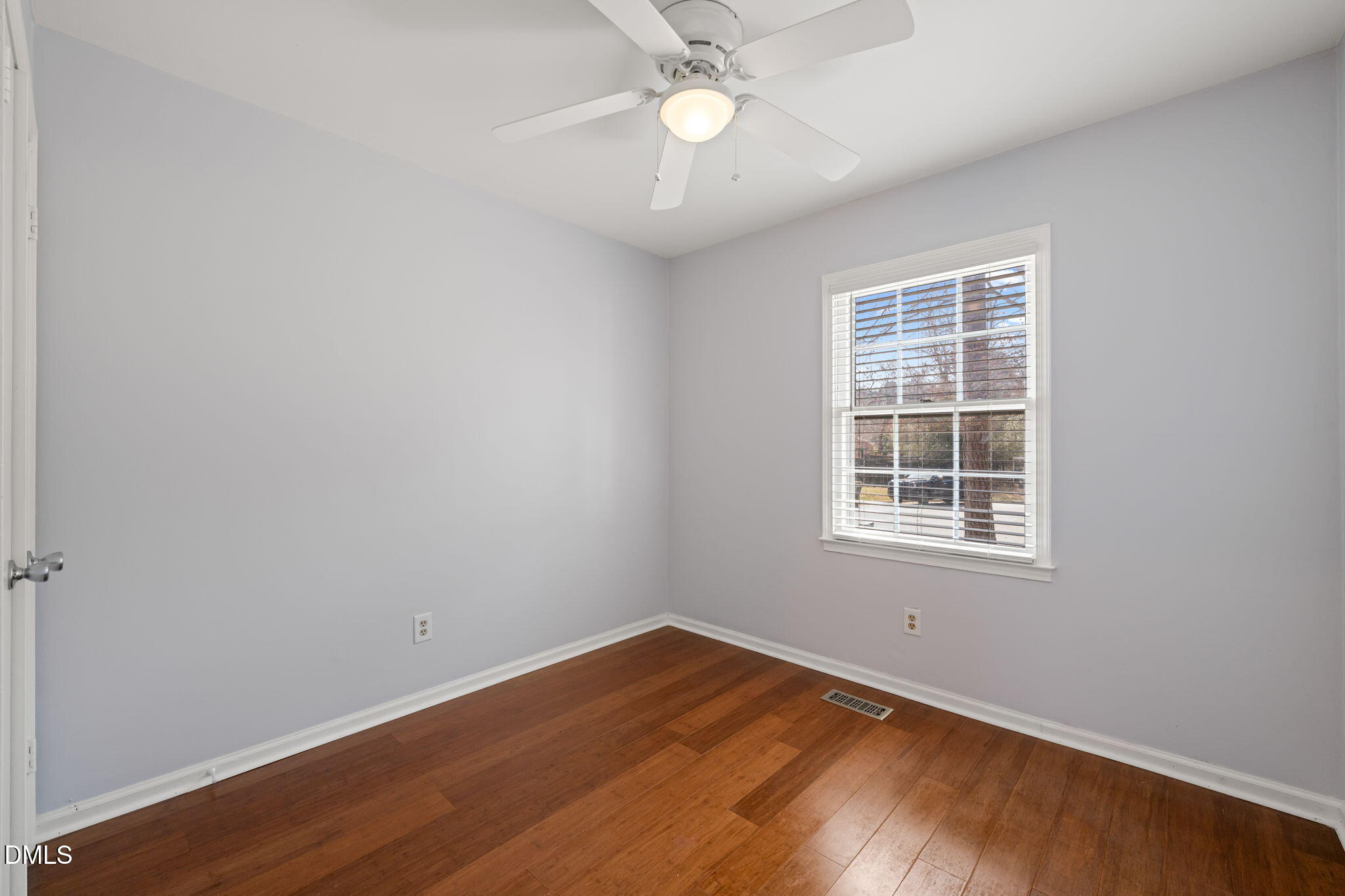 1004 Woodhill Court Raleigh, NC 27615 - Photo 20 of 43 an empty room with a window and wooden floor