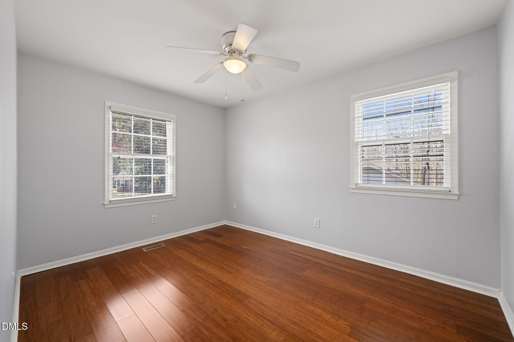 1004 Woodhill Court Raleigh, NC 27615 - Photo 22 of 43 a view of a room with wooden floor and fan