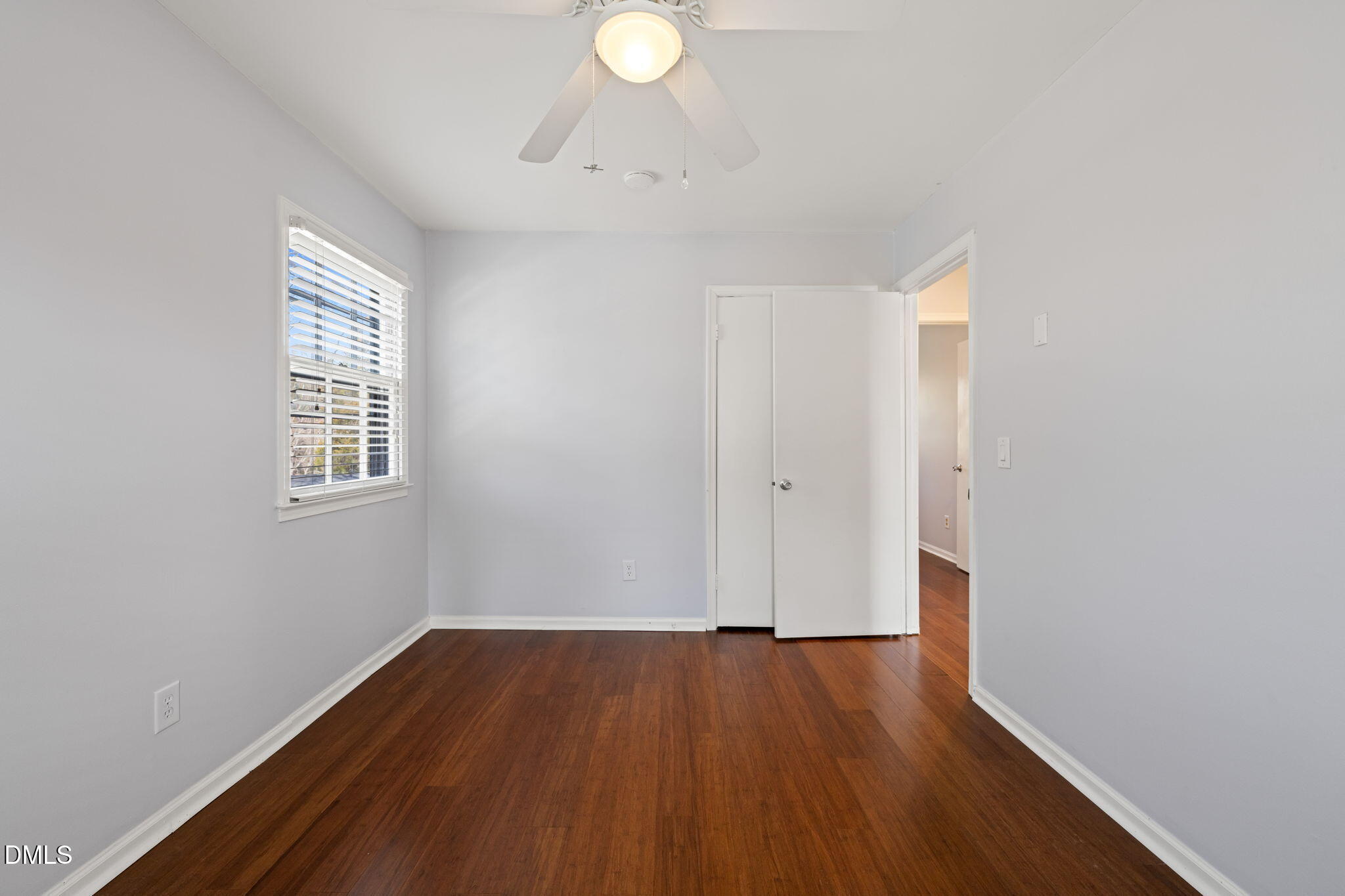 1004 Woodhill Court Raleigh, NC 27615 - Photo 23 of 43 a view of an empty room with wooden floor and a window