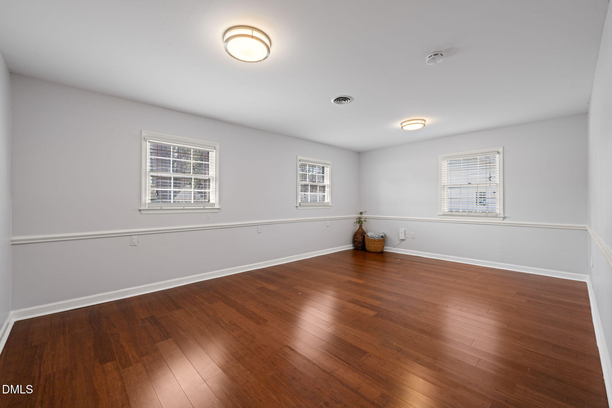 1004 Woodhill Court Raleigh, NC 27615 - Photo 25 of 43 an empty room with wooden floor and windows