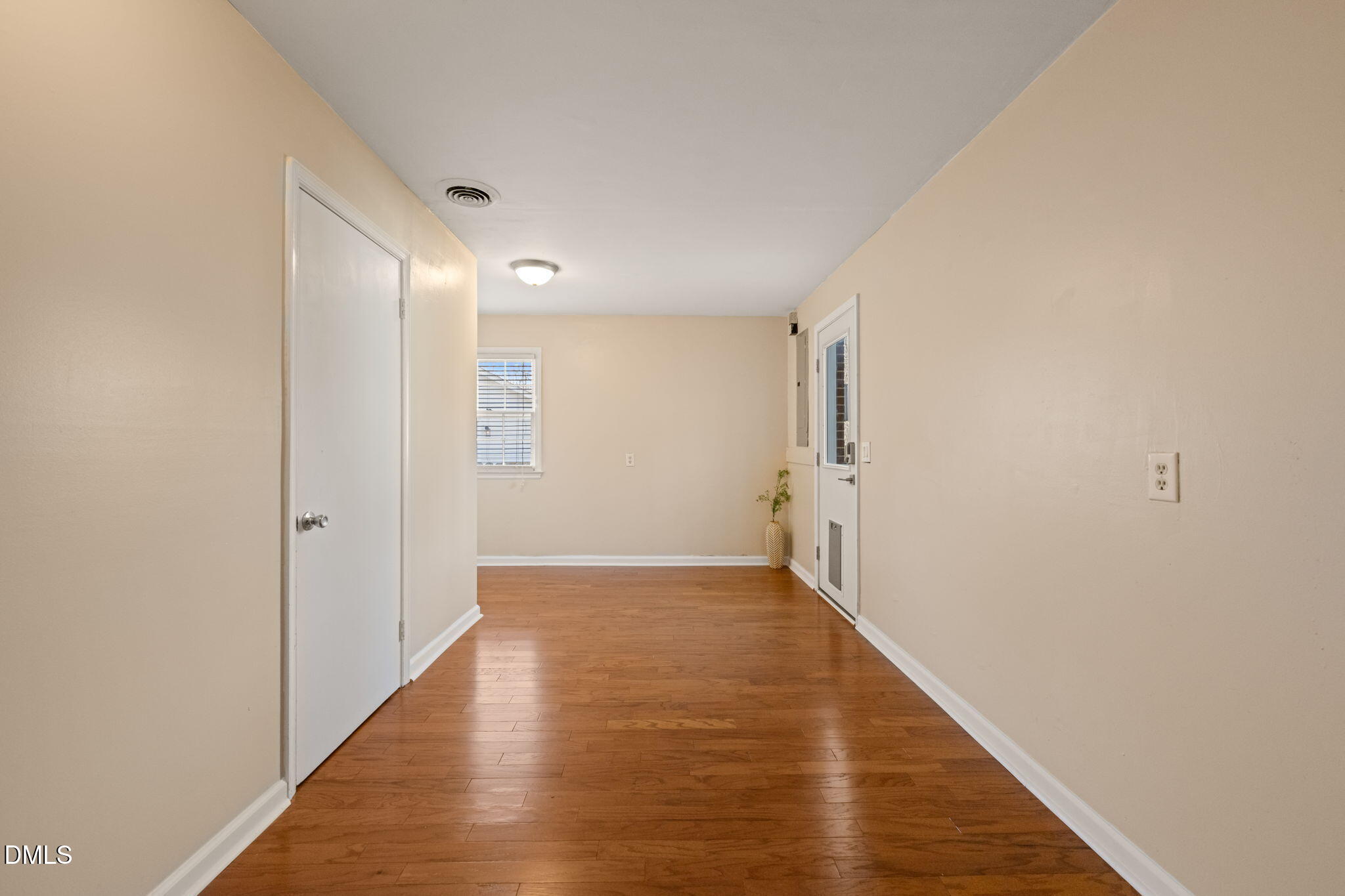 1004 Woodhill Court Raleigh, NC 27615 - Photo 29 of 43 a view of a hallway with wooden floor