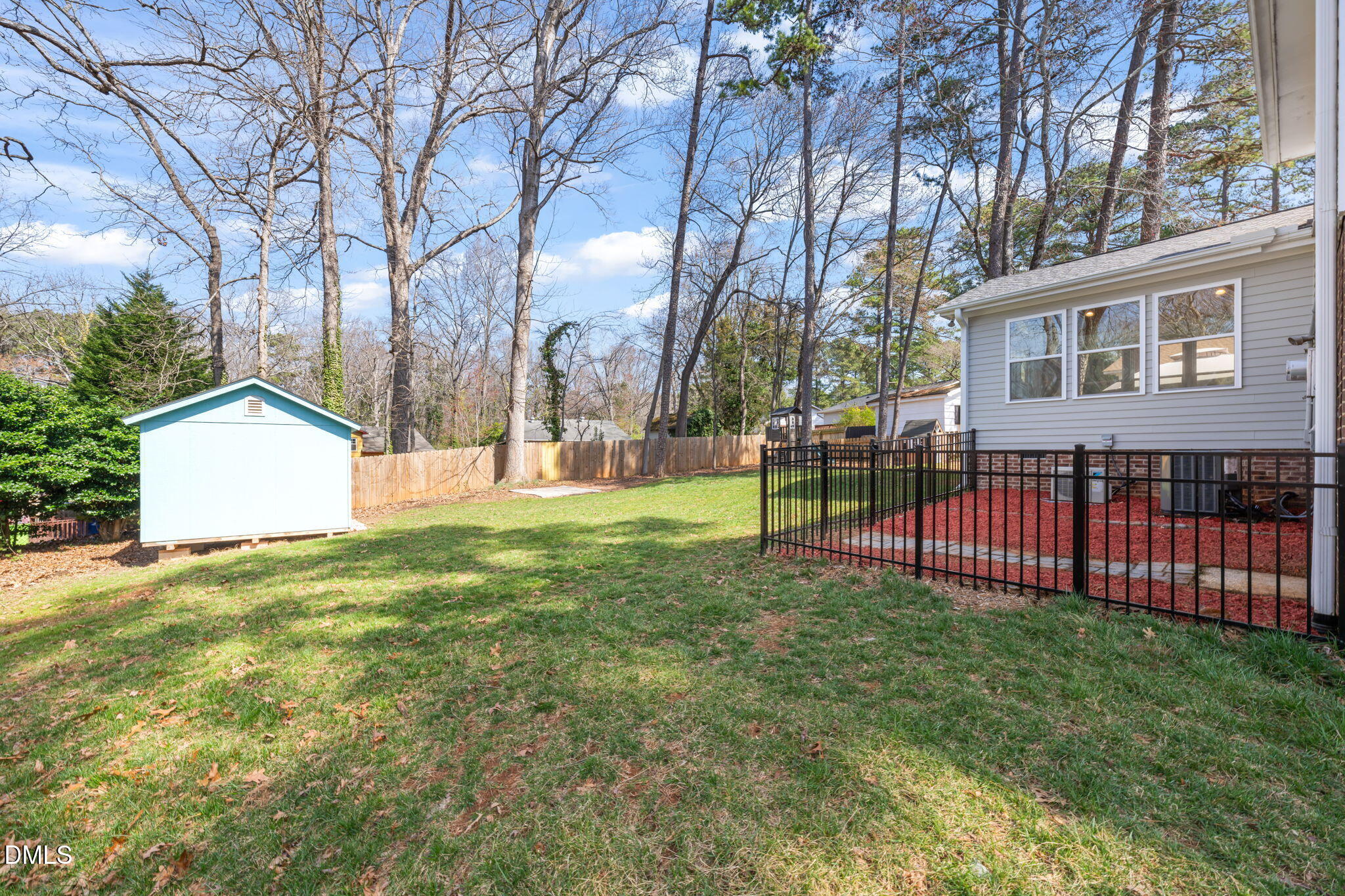 1004 Woodhill Court Raleigh, NC 27615 - Photo 32 of 43 a view of a house with backyard and a tree