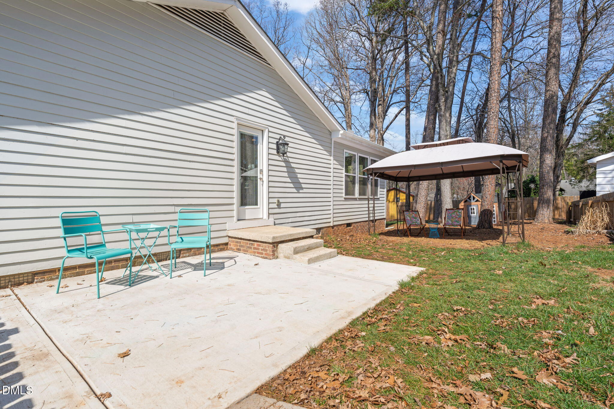 1004 Woodhill Court Raleigh, NC 27615 - Photo 37 of 43 a view of a patio with a table and chairs under an umbrella