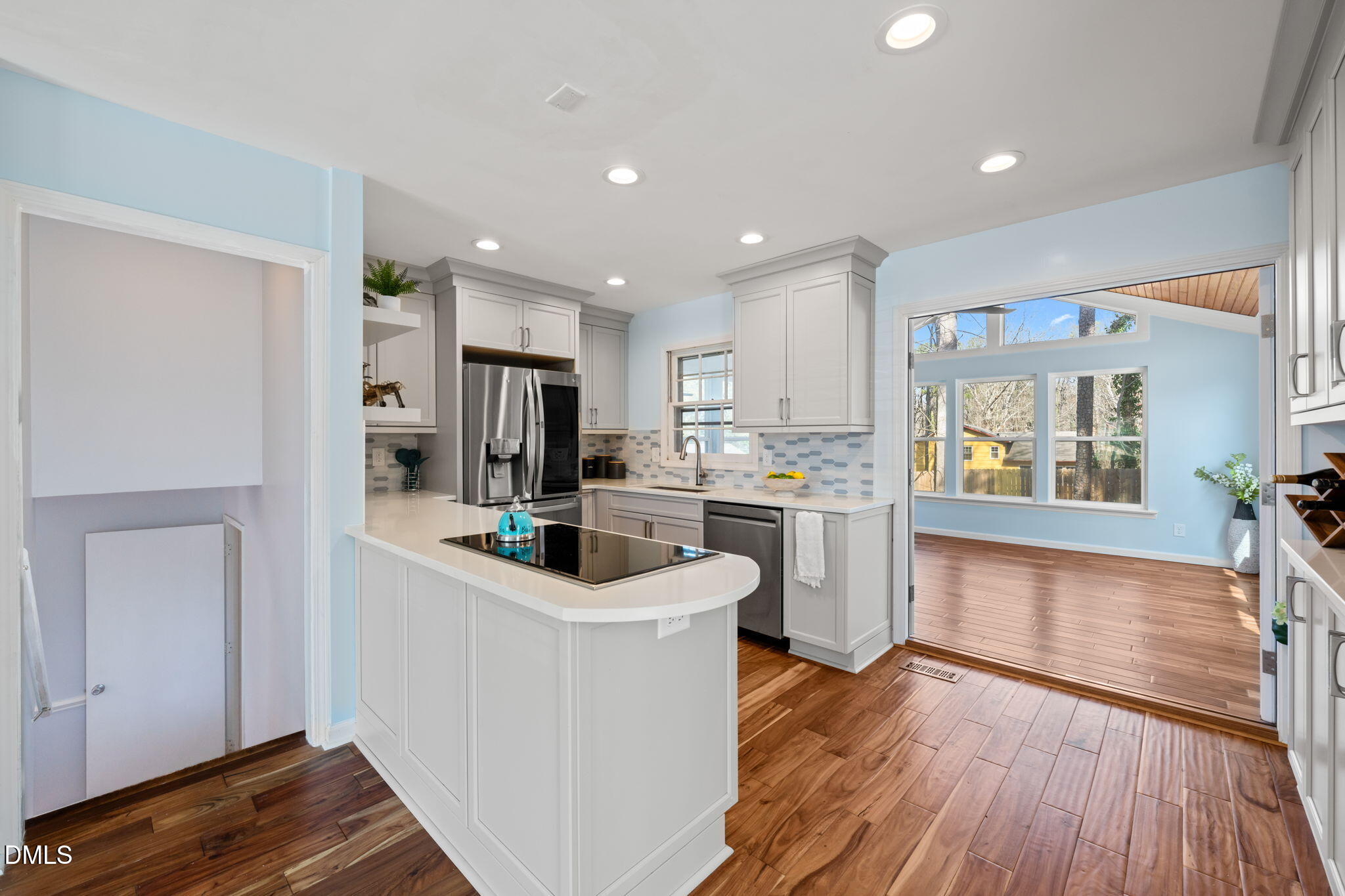 1004 Woodhill Court Raleigh, NC 27615 - Photo 7 of 43 a kitchen that has a lot of counter space and wooden floor
