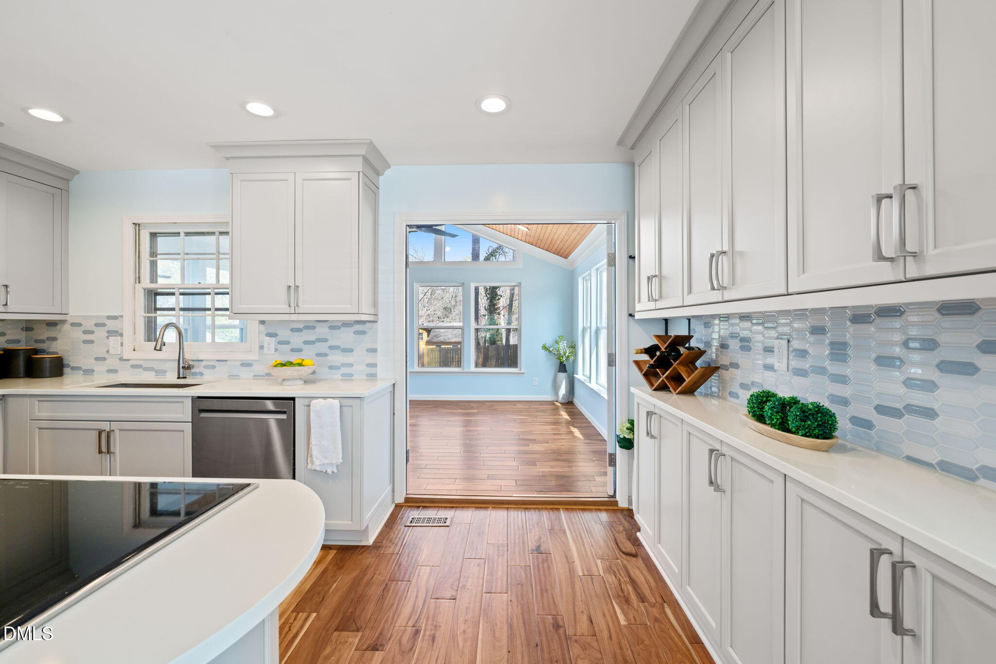1004 Woodhill Court Raleigh, NC 27615 - Photo 8 of 43 a kitchen with a white cabinets and wooden floor