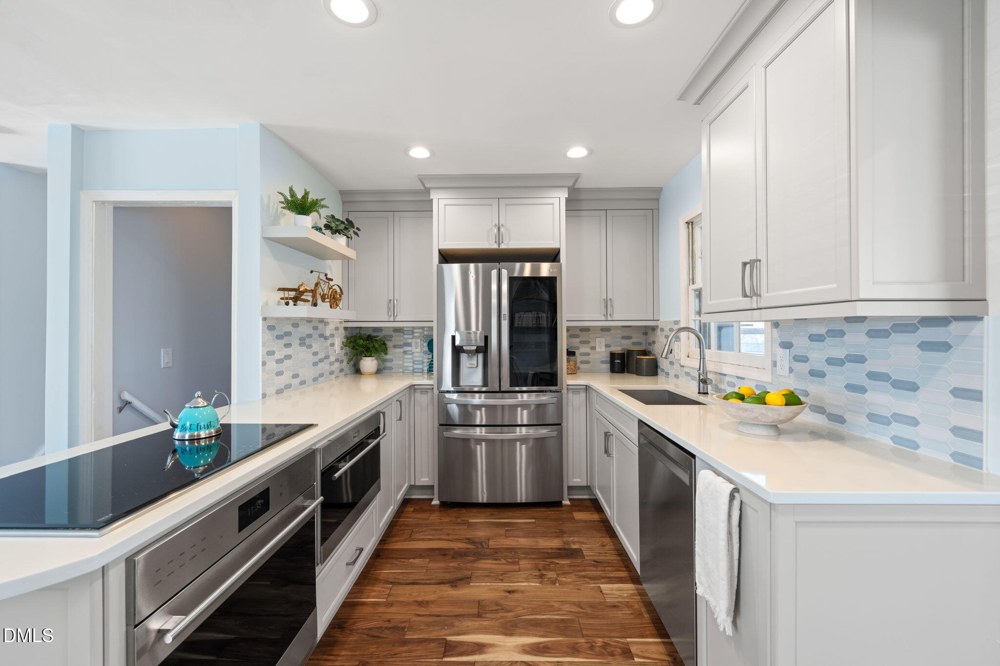 1004 Woodhill Court Raleigh, NC 27615 - Photo 9 of 43 a kitchen with stainless steel appliances a stove a sink and a refrigerator