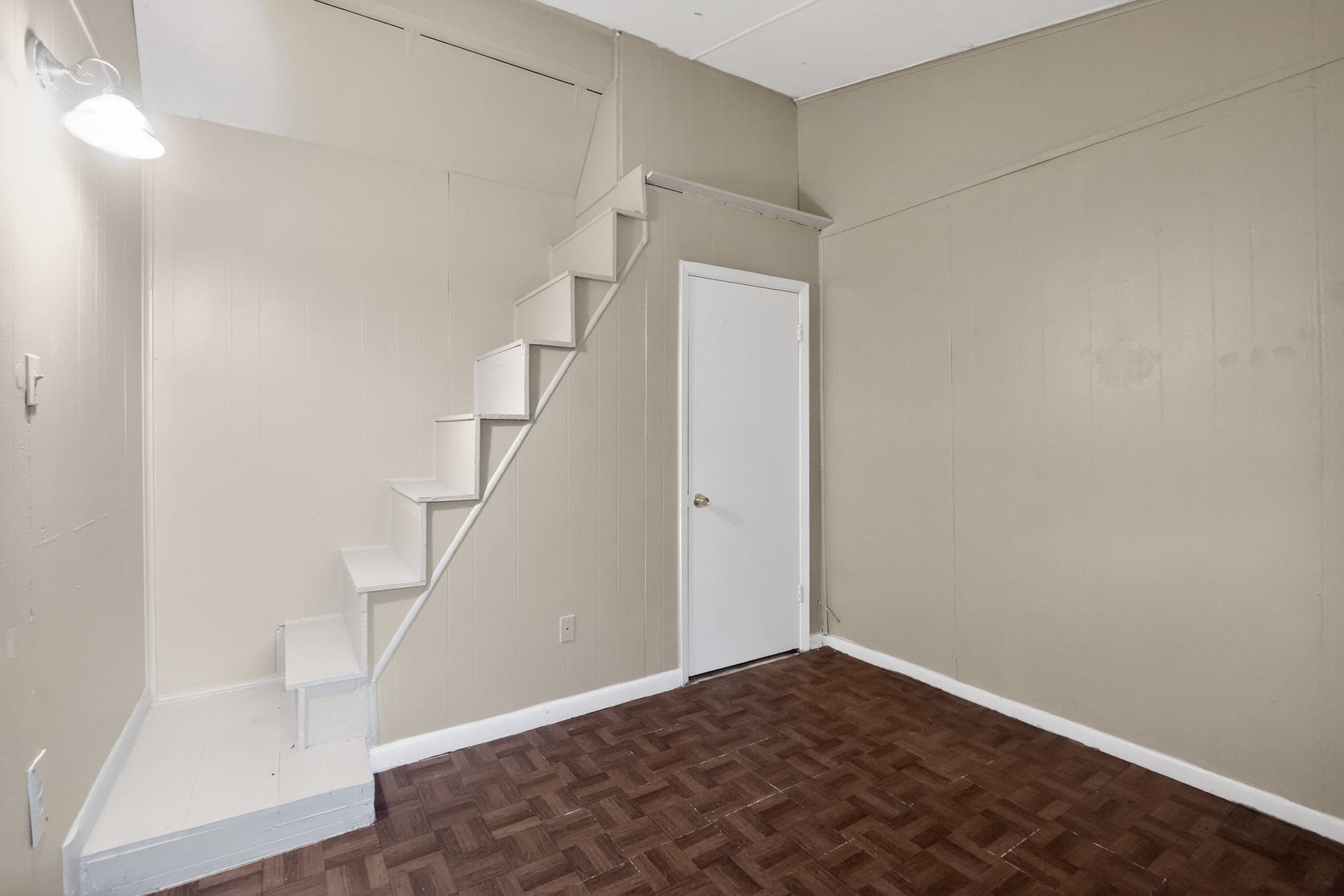 4504 Neely Road Memphis, TN 38109 - Photo 23 of 32 a view of hallway with stairs and wooden floor