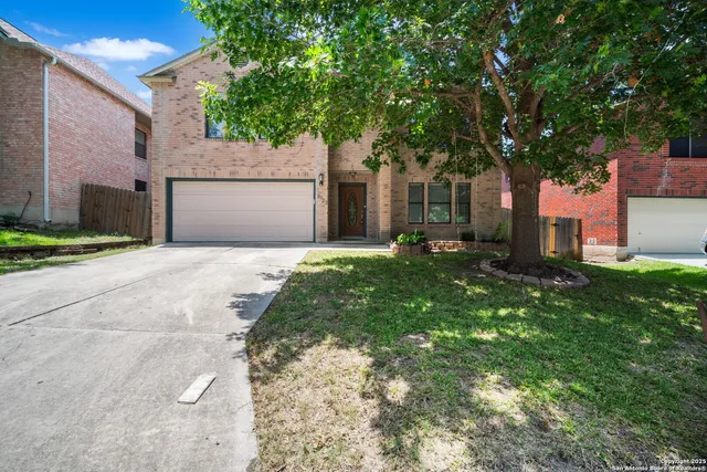 a front view of a house with a yard and a garage