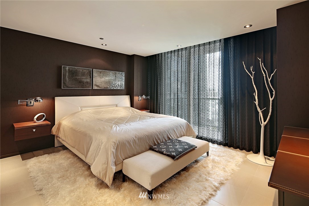 177 107th Avenue Northeast, Unit 1202 Bellevue, WA 98004 - Photo 13 of 25 a bed sitting in a bedroom next to a window