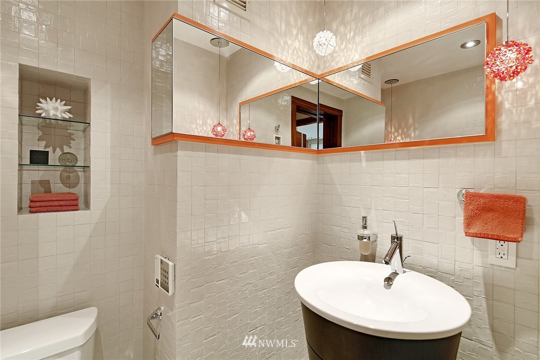 177 107th Avenue Northeast, Unit 1202 Bellevue, WA 98004 - Photo 23 of 25 a bathroom with a sink a mirror and a toilet