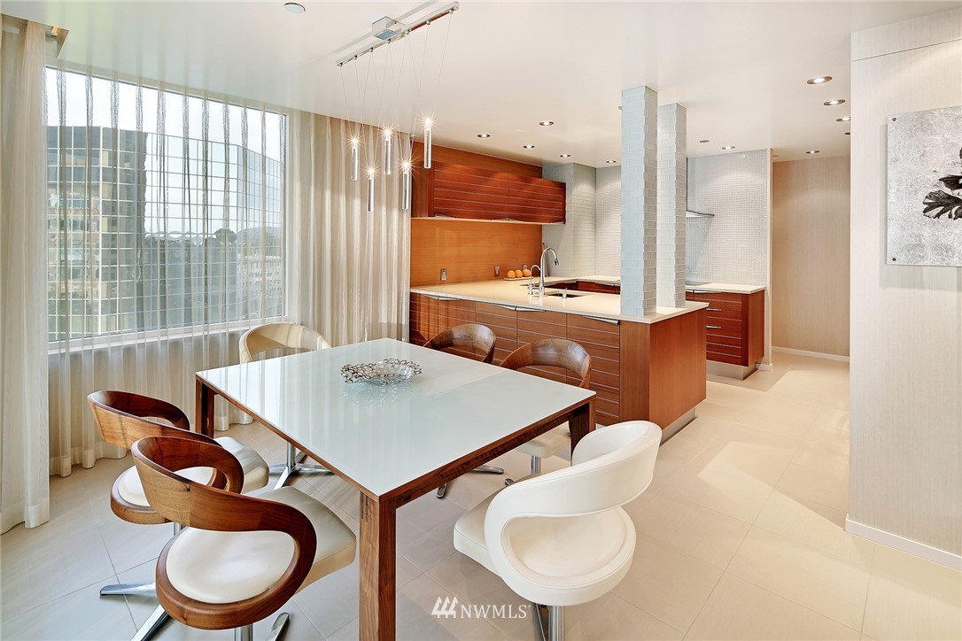 177 107th Avenue Northeast, Unit 1202 Bellevue, WA 98004 - Photo 6 of 25 a kitchen with a table chairs sink and cabinets