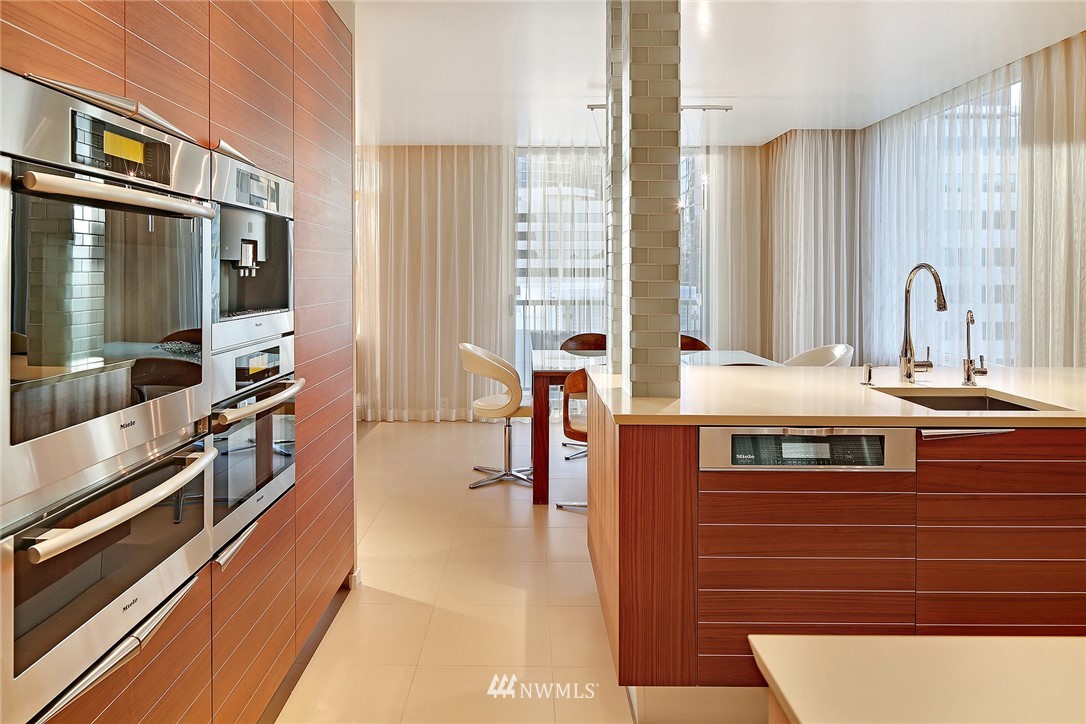177 107th Avenue Northeast, Unit 1202 Bellevue, WA 98004 - Photo 8 of 25 a kitchen with stainless steel appliances a sink and cabinets