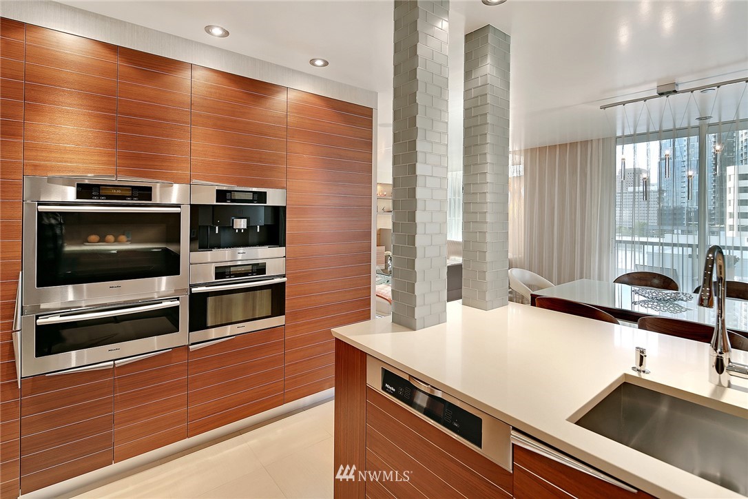 177 107th Avenue Northeast, Unit 1202 Bellevue, WA 98004 - Photo 10 of 25 a kitchen with stainless steel appliances a stove and a microwave