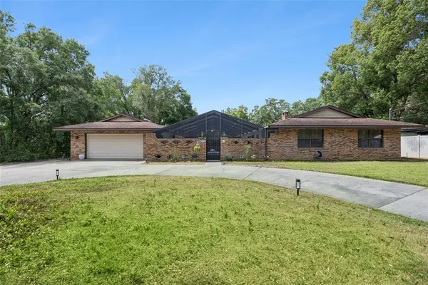 a front view of house with yard and trees