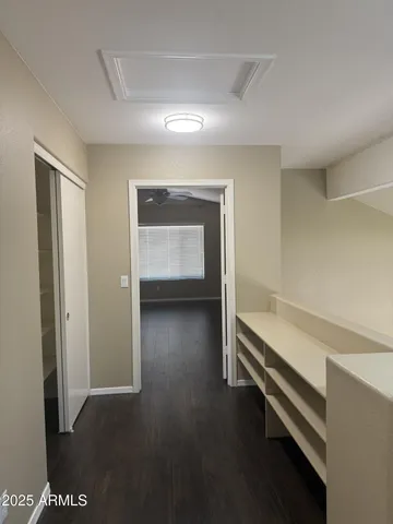 a view of empty room with wooden floor