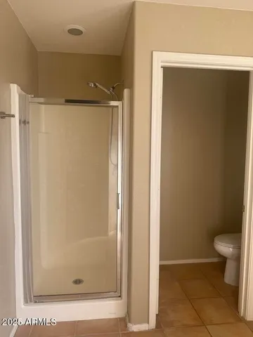 a bathroom with a glass shower door
