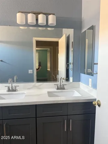 a bathroom with a sink vanity and a mirror