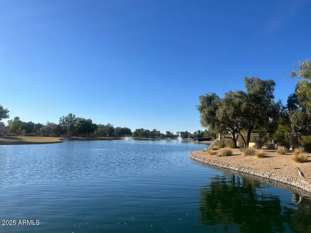 a view of a lake with houses in the back