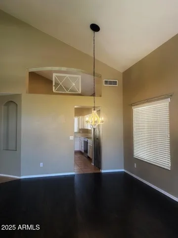 a view of a room with wooden floor closet and windows