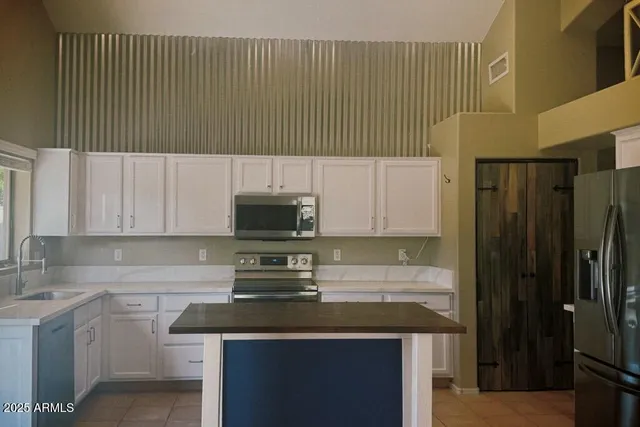 a kitchen with a sink a stove and cabinets