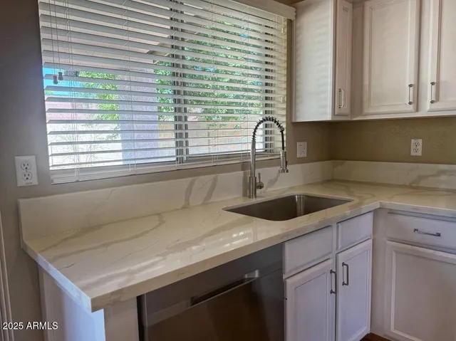 a kitchen with a sink and cabinets