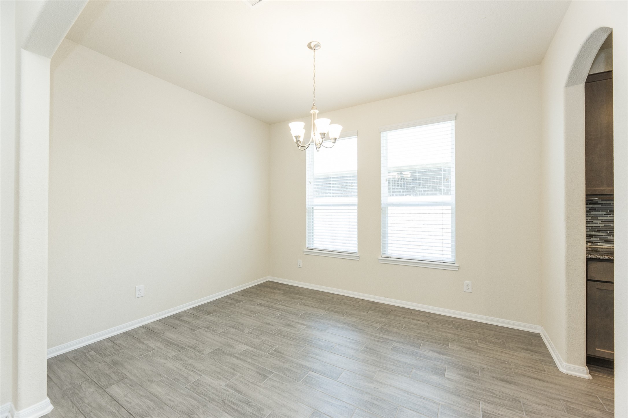 2293 Garden Square Path Spring, TX 77386 - Photo 9 of 32 an empty room with wooden floor and windows
